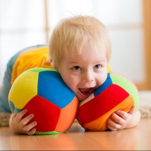 Boy playing with cloth balls