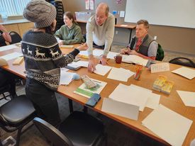 Parents working on art projects at Educare Central Maine Workshop